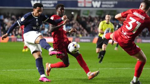 Millwall's Femi Azeez strikes a volleyed goal against Birmingham City.