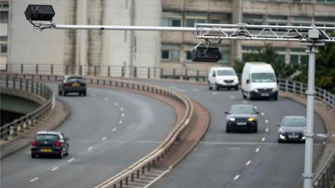 The Mancunian Way, a motorway, with light traffic way travelling in either direction in the day time.