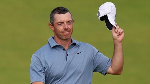 Rory McIlroy acknowledges the crowd while walking to the final green on Sunday