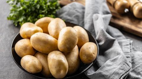 Potatoes shown in a bowl in a kitchen 