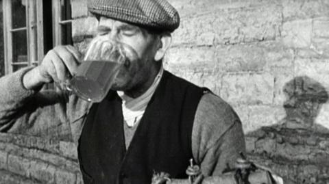 A man drinking a beer