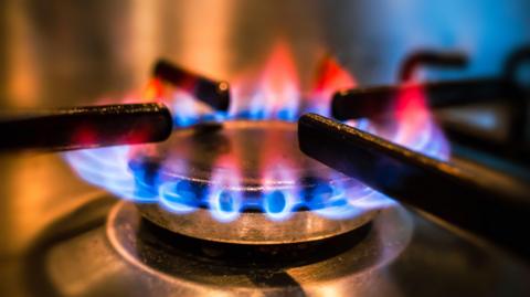 A close-up of flames on a gas hob. 