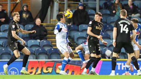 Blackburn and Oxford players competing for the ball