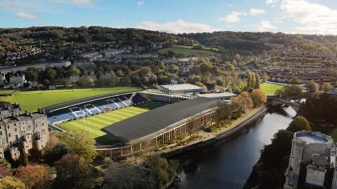 A computer generated image of what the stadium could look like north of the river, with green space to the north of the stadium, and surrounded by buildings to the east and west.
