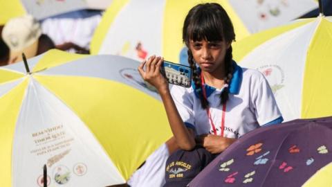 Catholic faithful wait for a mass led by Pope Francis at Tasitolu park in Dili, East Timor on September 10, 2024