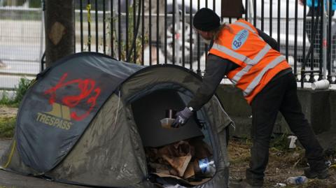 Volunteer removing tents