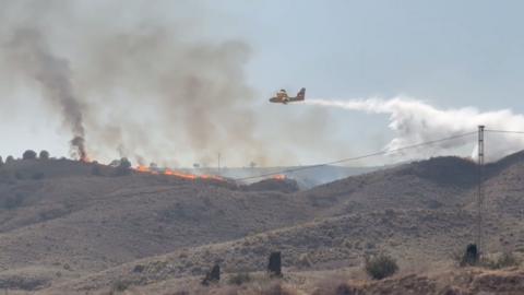 Water coming out of a plane over wildfire.
