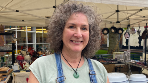 Jane Bundy standing in front of a market stall