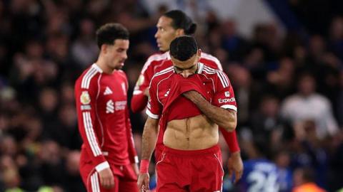 Liverpool players look disappointed after their loss to Chelsea