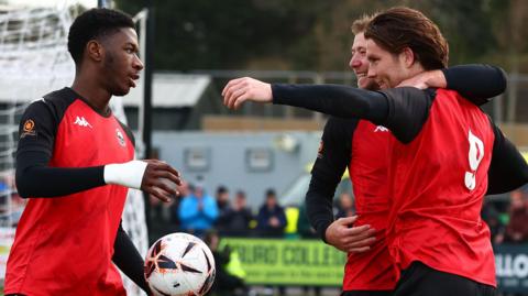 Truro City players celebrate a win