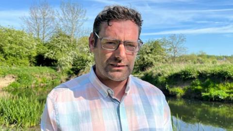 Seamus Sullivan stood near the River Erewash on land which he owns.