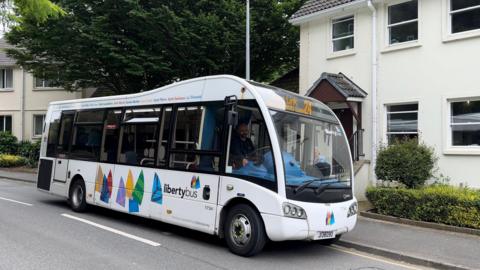 Bus stops directly outside woman's front door