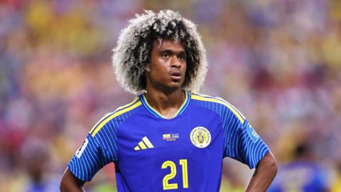Tahith Chong, wearing his blue and yellow Curacao kit, looks on during the side's match against Ecuador on Sunday