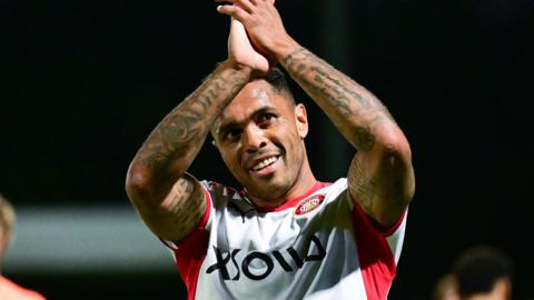Josh Magennis applauds fans after his late winner for Stevenage