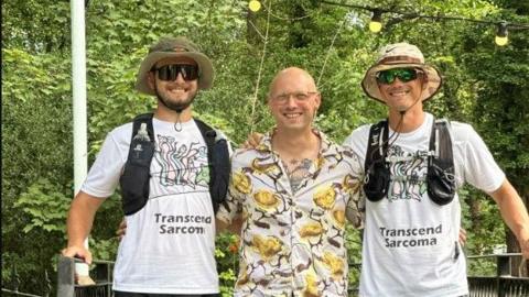 Jack Holmes (middle) pictured with his brothers who ran seven marathons in seven days 