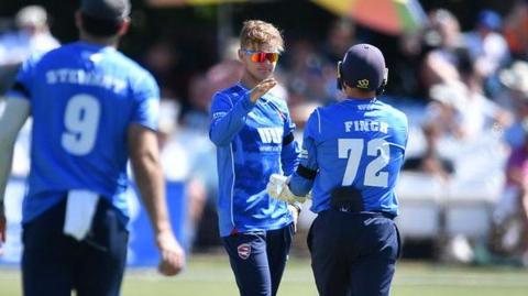 Jadyn Denly high-fives his Kent teammate, Harry Finch