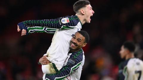 Wilson Isidor raises Sunderland team-mate Chris Rigg into the air following their win over Middlesbrough