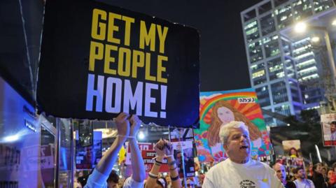 People protest calling for action to secure the release of Israelis held hostage in Gaza, in front of the Israeli defence ministry in Tel Aviv on 15 January 2025.