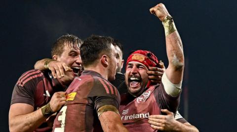 Munster players celebrate a try against Saracens