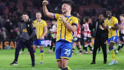 Louis Reed punches the air in celebration