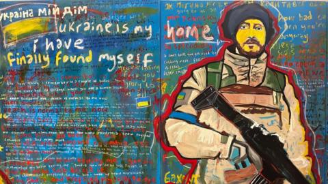 A painting of a Ukrainian soldier carrying a large gun. The background is composed of mostly blue with red, yellow and green, and features messages in Ukrainian and English regarding the war in Ukraine.