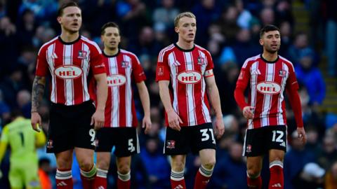 Exeter City players look forlorn after conceding a goal