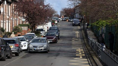 A number of cars wait outside Hotspur Primary School at Mowbray Street in Heaton, Newcastle.