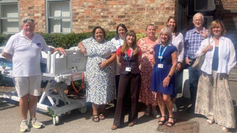 Staff and donators at St Leonard's Hospice with the cuddle beds