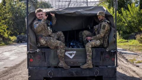 Ukrainian troops on a jeep in Russia's Kursk region