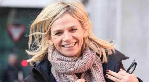 Zoe Ball in a scarf and coat, smiling