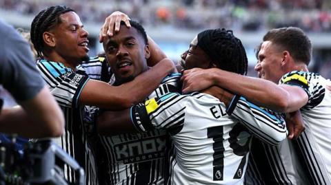 Joe Willock celebrates with his Newcastle United team-mates after scoring against Liverpool at St James' Park on 23 August, 2026