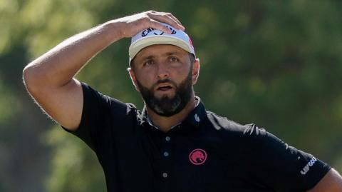 Jon Rahm has his hand on his head
