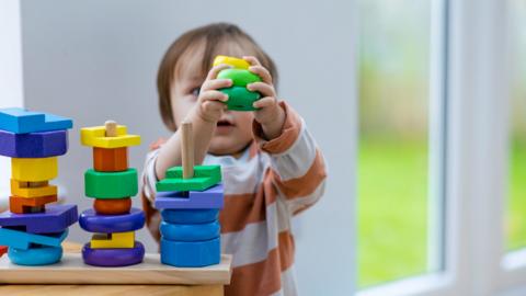 A child plays with building blocks
