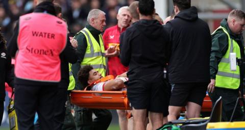 Andy Onyeama-Christie being stretchered off