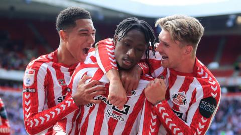 Sunderland players congratulate Romaine Mundle (centre) after his goal against Burnley