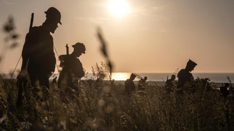 Silhouettes of the 'Standing with Giants' installation are displayed at the British Memorial ahead of the 80th D-Day anniversary, in Ver-sur-Mer, France