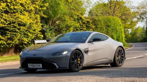 Aston Martin Vantage car driving on a country road