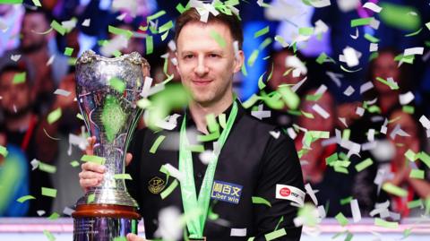 Judd Trump lifts the UK Championship trophy