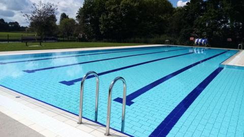 A view of Abbey Meadows pool on a sunny day. There is no one in the pool.