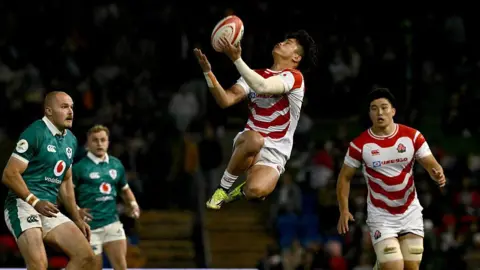 Japan's Kazuma Ueda catches the ball