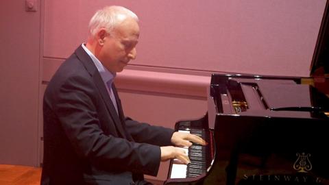 Steve Rosenberg sits at a piano