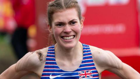 Megan Keith with mud on her shoulder after winning the European Under-23 Cross Country title in 2023