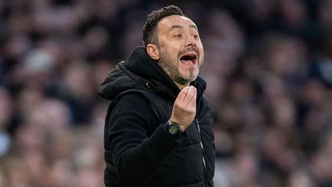 Roberto de Zerbi gesticulates with his hands while on the sidelines as Tottenham boss