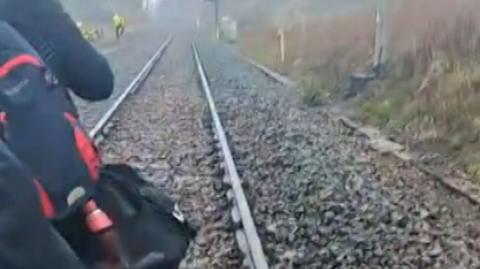 A man walking on train track
