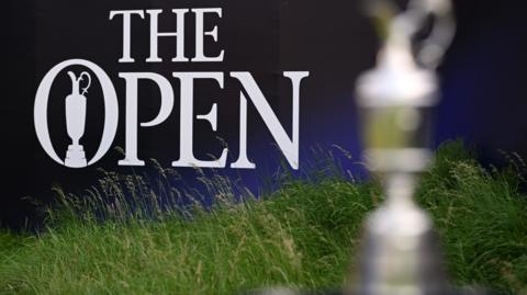 A generic image of The Open sign with a blurred Claret Jug in the foreground