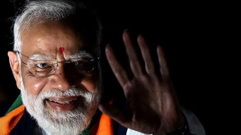 INDIA-POLITICS-ELECTION India's Prime Minister Narendra Modi greets his supporters during a roadshow in Kolkata on April 26, 2026 ahead of the second phase of the West Bengal Legislative Assembly elections. (Photo by Dibyangshu SARKAR / 