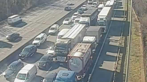 A traffic camera images shows the anticlockwise lane is full of stationary cars and lorries. 