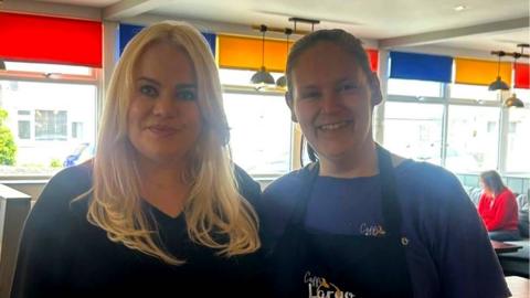 A woman with long blonde hair stood next to a woman with brown hair