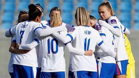 England players in a huddle before kick-off