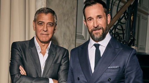 George Clooney and Noah Wyle - both in suits looking at the camera.